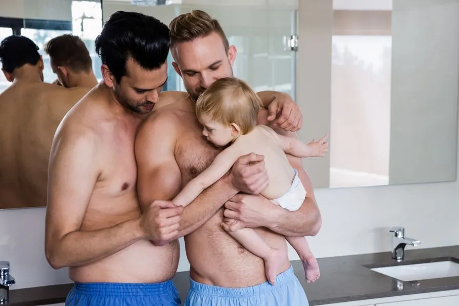 Two dads bonding with baby